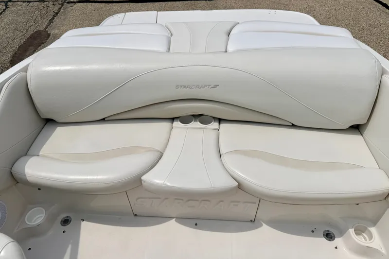 Slide: The Image of 2005 Starcraft 2100 IO RE Limited boat interior with white leather seating and cup holders. - 31