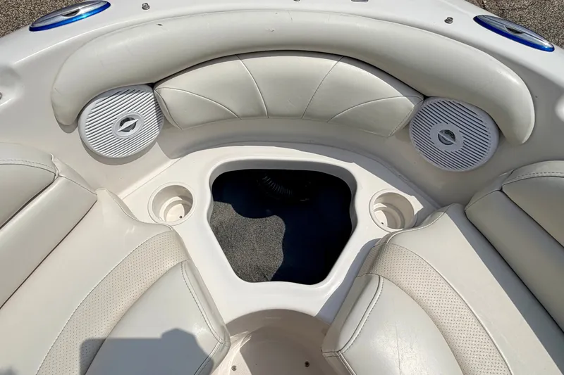 Slide: The Image of Interior of 2005 Starcraft 2100 IO RE Limited boat with white seating and speakers. - 62