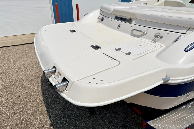 Slide: The Image of 2005 Starcraft 2100 IO RE Limited boat, rear view, showcasing swim platform and seating area. - 18