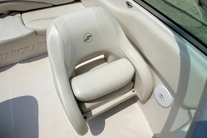 Slide: The Image of White leather seat in a 2005 Starcraft 2100 IO RE Limited boat interior. - 53