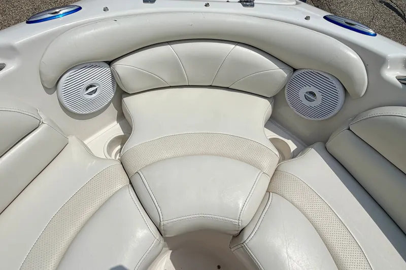 Slide: The Image of Interior seating of 2005 Starcraft 2100 IO RE Limited boat with white upholstery and speakers. - 61