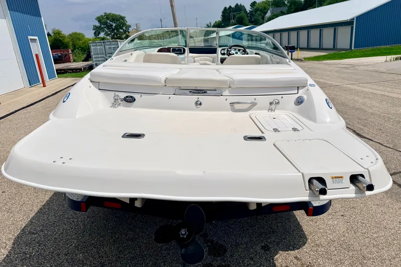 Slide: The Image of 2005 Starcraft 2100 IO RE Limited boat, rear view, parked outdoors on a sunny day. - 19