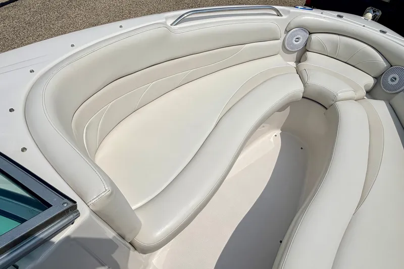 Slide: The Image of 2005 Starcraft 2100 IO RE Limited boat interior with white cushioned seating. - 59