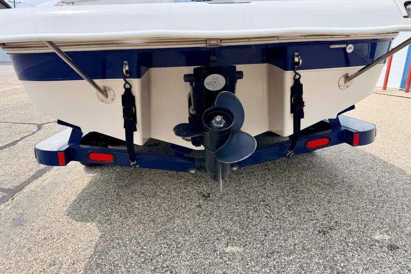 Slide: The Image of Rear view of a 2005 Starcraft 2100 IO RE Limited boat on a trailer. - 82