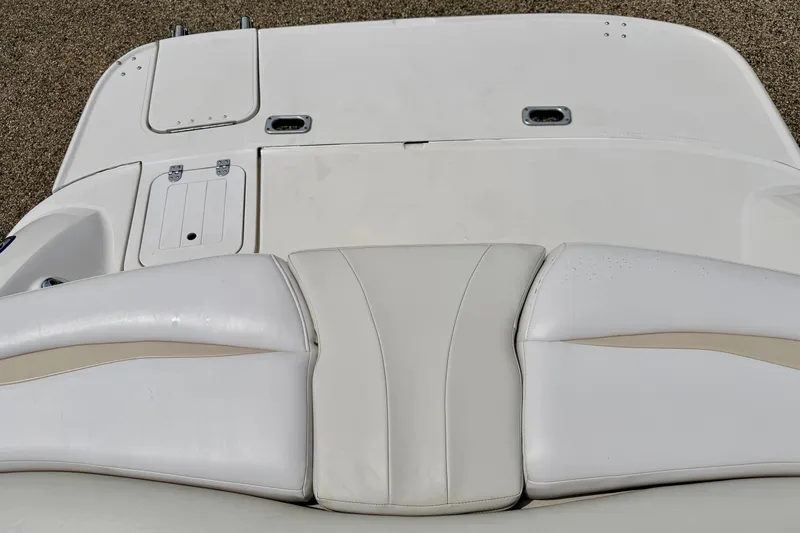 Slide: The Image of 2005 Starcraft 2100 IO RE Limited boat interior with white cushioned seating. - 30