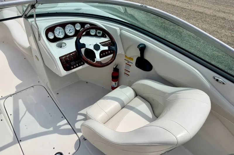 Slide: The Image of 2005 Starcraft 2100 IO RE Limited boat interior with steering wheel and gauges. - 42