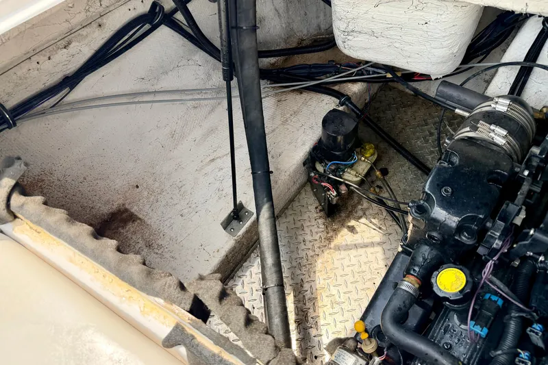 Slide: The Image of Engine compartment of a 2005 Starcraft 2100 IO RE Limited boat, showing mechanical components. - 35
