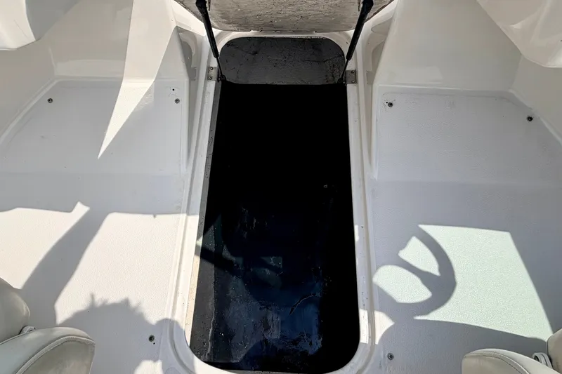 Slide: The Image of Interior view of a 2005 Starcraft 2100 IO RE Limited boat, showcasing seating and flooring. - 57