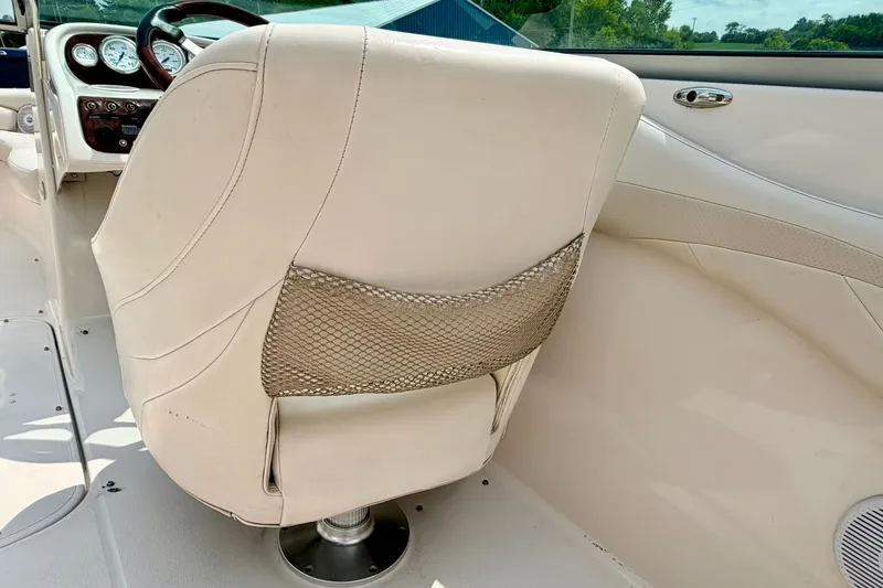 Slide: The Image of Interior of a 2005 Starcraft 2100 IO RE Limited boat with beige seating. - 74
