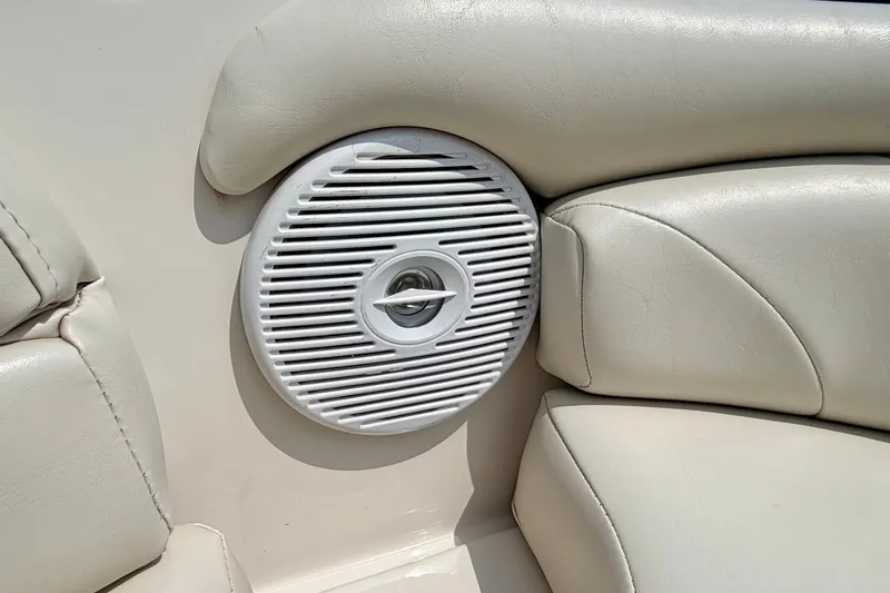 Slide: The Image of White speaker on beige leather seating, 2005 Starcraft 2100 IO RE Limited boat interior. - 65