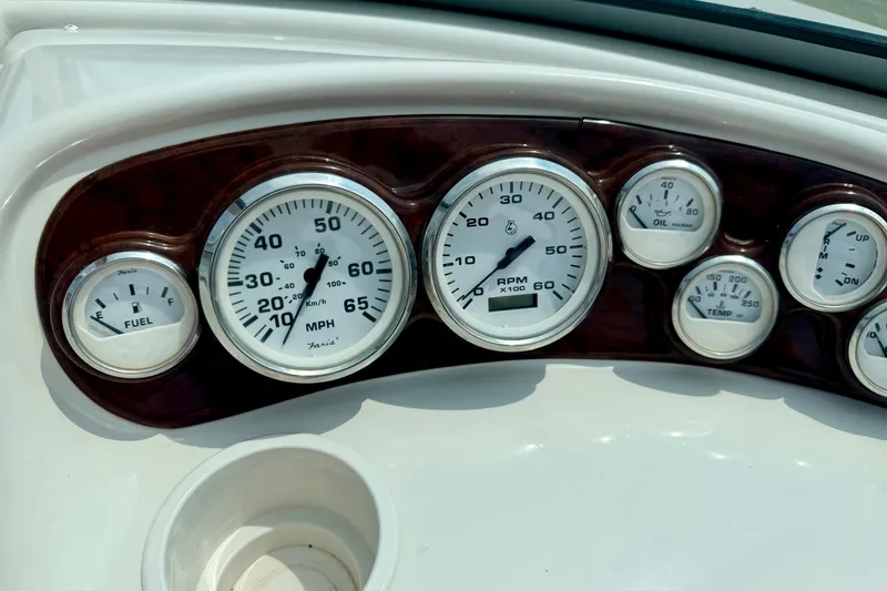 Slide: The Image of Dashboard of a 2005 Starcraft 2100 IO RE Limited boat with various gauges. - 44