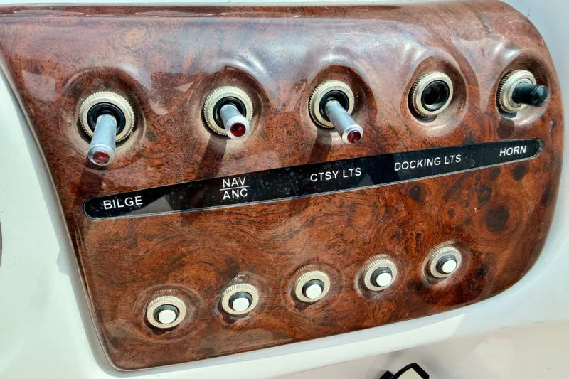 Slide: The Image of Control panel of a 2005 Starcraft 2100 IO RE Limited boat with labeled switches. - 47