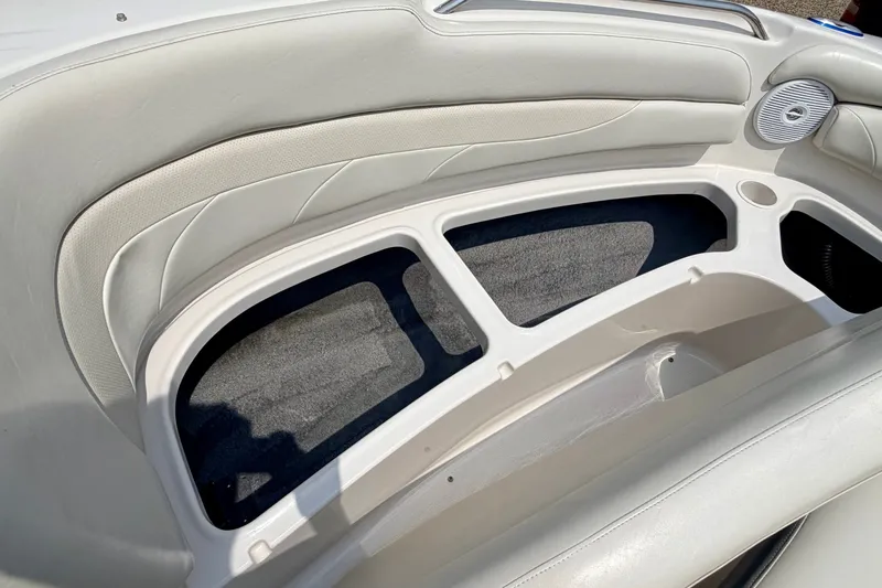 Slide: The Image of 2005 Starcraft 2100 IO RE Limited boat interior with white seating and storage compartments. - 60