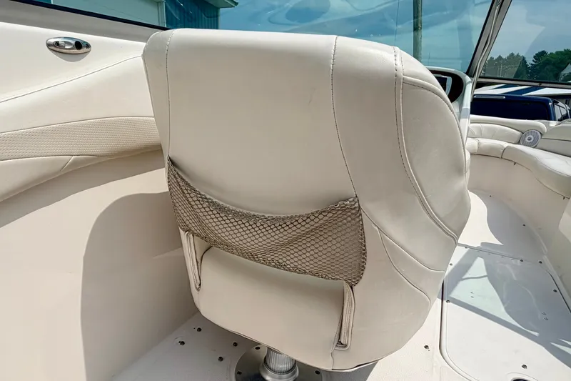 Slide: The Image of 2005 Starcraft 2100 IO RE Limited boat interior with white leather seating and mesh pocket. - 73