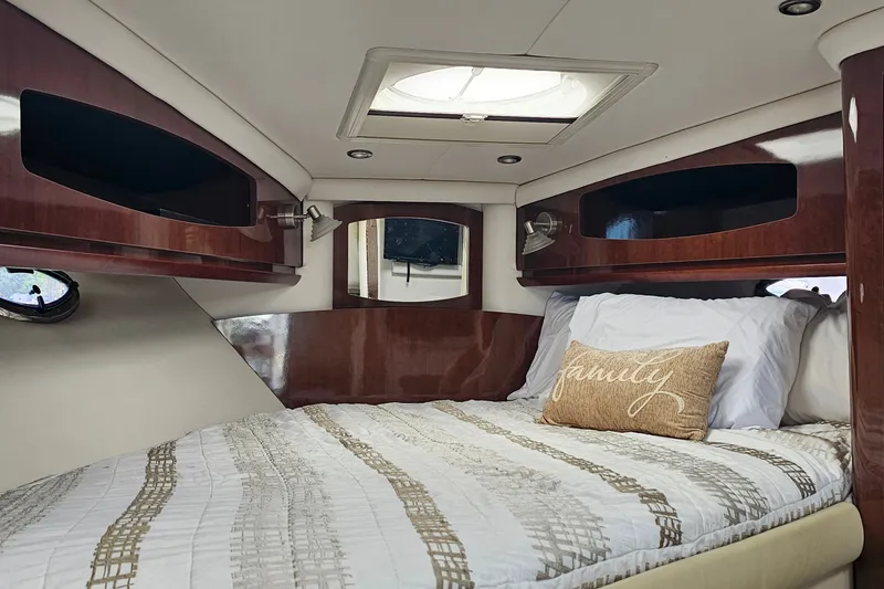 Slide: The Image of Luxurious cabin interior of 2013 Four Winns V335 boat with cozy bedding and elegant wood finish. - 9