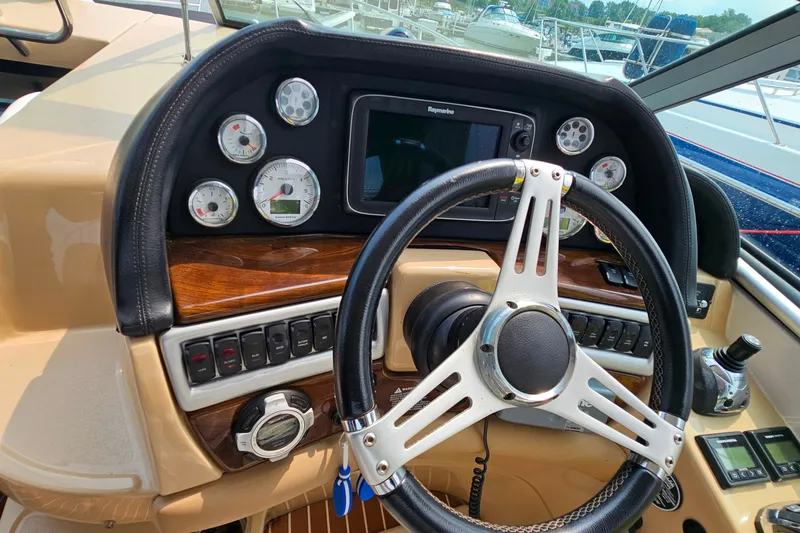 Slide: The Image of Steering console of 2013 Four Winns V335 boat with gauges and controls. - 41