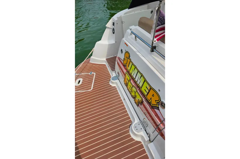 Slide: The Image of 2013 Four Winns V335 boat deck with "Summer Fest" sign and American flag. - 56