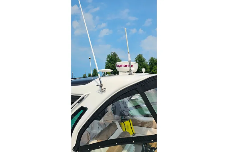 Slide: The Image of 2013 Four Winns V335 boat with Raymarine radar and antennas against blue sky. - 50