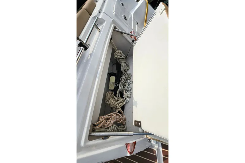 Slide: The Image of Storage compartment on 2013 Four Winns V335 boat with ropes and equipment. - 53