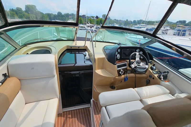 Slide: The Image of Interior view of 2013 Four Winns V335 boat cockpit with steering wheel and seating. - 34