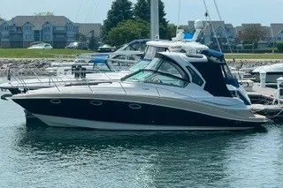 The Image of 2013 Four Winns V335 yacht docked in a marina, showcasing sleek design and modern features. - 0