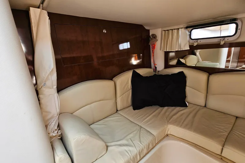 Slide: The Image of Interior of 2013 Four Winns V335 yacht with beige seating and dark wood accents. - 28