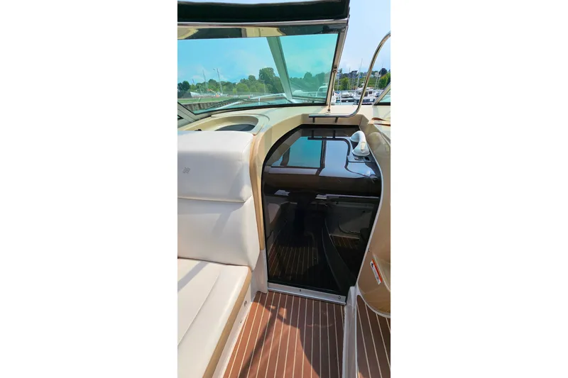 Slide: The Image of Interior view of 2013 Four Winns V335 boat, featuring seating and cabin entrance. - 43