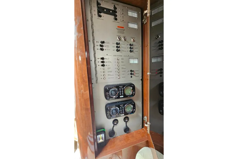 Slide: The Image of Control panel of a 2013 Four Winns V335 boat, featuring switches and gauges. - 22