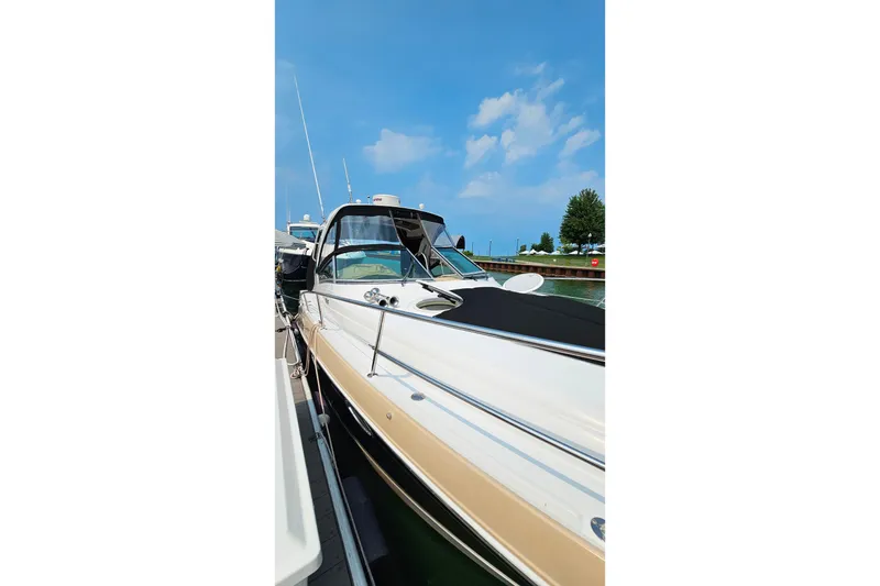 Slide: The Image of 2013 Four Winns V335 boat docked under a clear blue sky. - 47