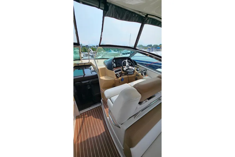 Slide: The Image of Interior view of 2013 Four Winns V335 boat cockpit with steering wheel and seating. - 35