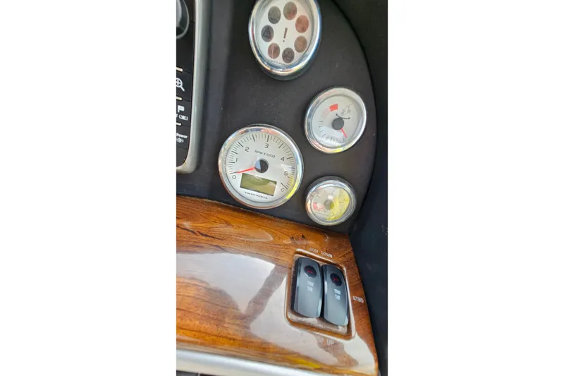 Slide: The Image of Dashboard of a 2013 Four Winns V335 boat with gauges and controls. - 38