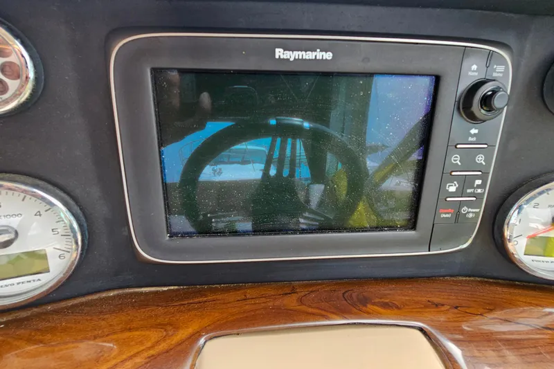 Slide: The Image of Raymarine navigation system on 2013 Four Winns V335 boat dashboard with gauges. - 40