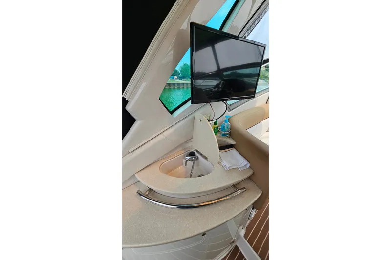 Slide: The Image of Interior of 2013 Four Winns V335 yacht with sink and mounted TV. - 61