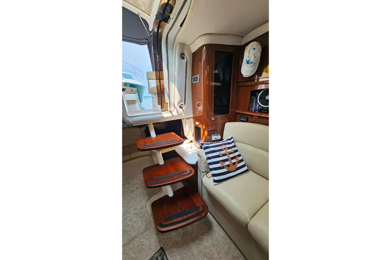 Slide: The Image of Interior of 2013 Four Winns V335 boat with wooden steps and nautical decor. - 20