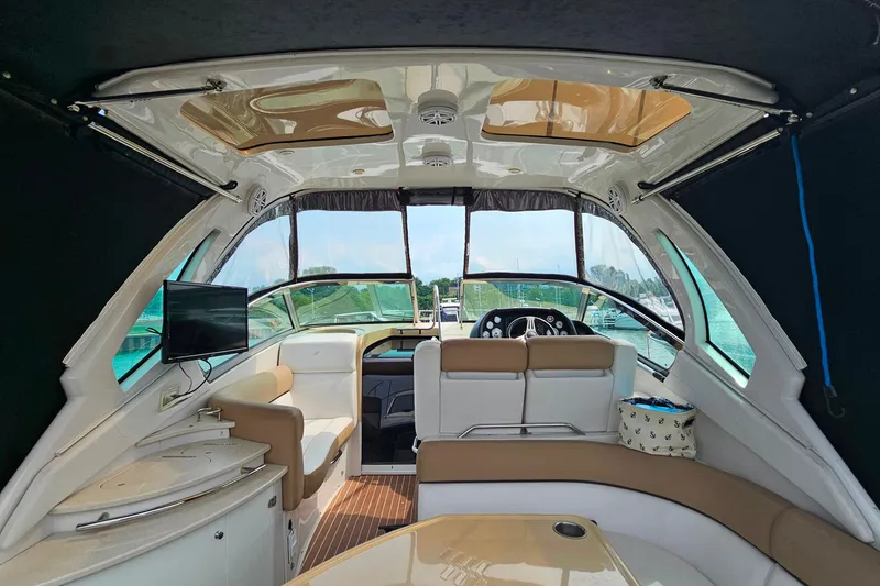 Slide: The Image of Interior of 2013 Four Winns V335 boat with seating, TV, and helm. - 29