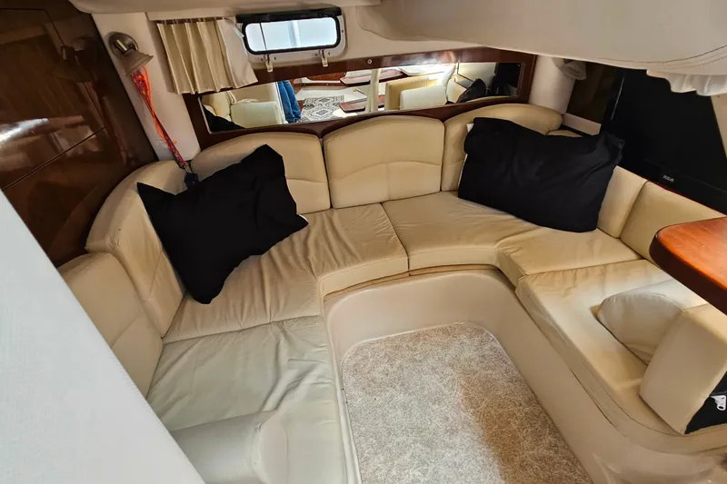 Slide: The Image of Interior of 2013 Four Winns V335 yacht with beige seating and black cushions. - 25