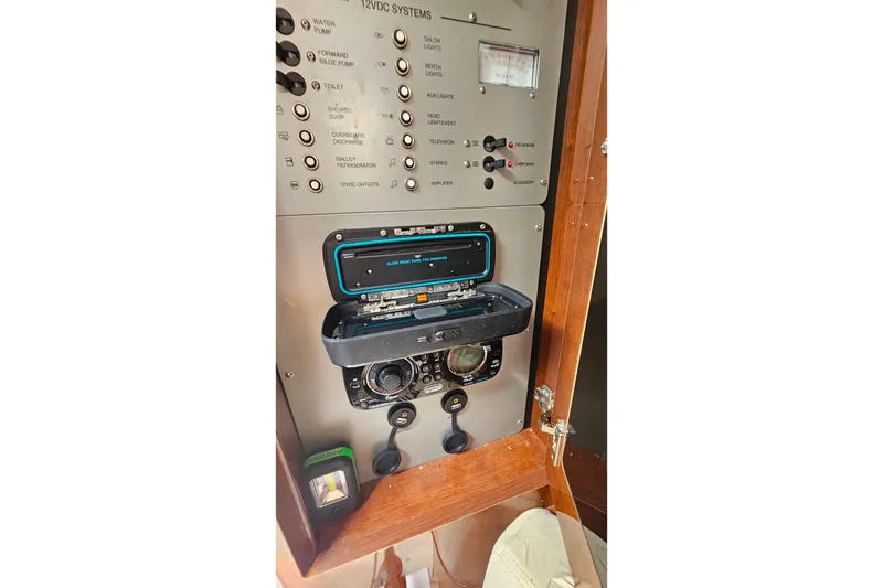 Slide: The Image of Control panel of a 2013 Four Winns V335 boat, featuring various switches and gauges. - 23