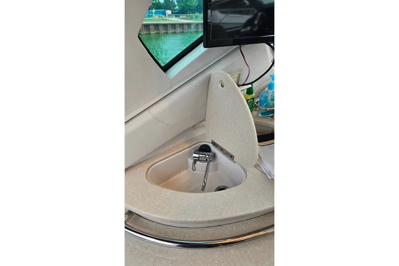 Slide: The Image of Interior of 2013 Four Winns V335 boat featuring a compact sink area. - 60