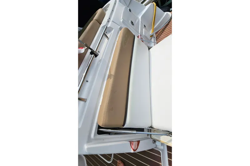 Slide: The Image of 2013 Four Winns V335 boat interior with beige and white seating. - 54