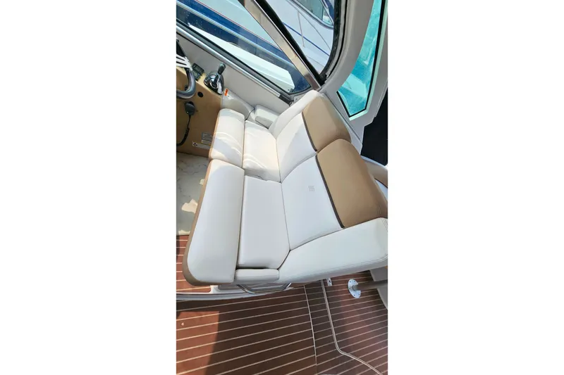 Slide: The Image of Interior seating of 2013 Four Winns V335 boat with beige and white upholstery. - 36