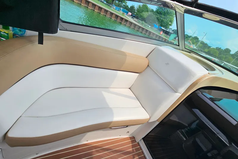 Slide: The Image of Interior seating of 2013 Four Winns V335 boat with tan and white upholstery. - 33