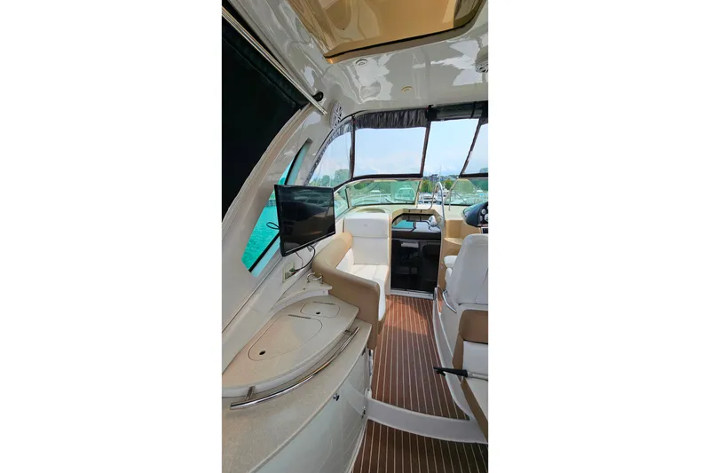 Slide: The Image of Interior of 2013 Four Winns V335 boat with seating, TV, and helm view. - 31