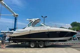 Slide: The Image of 2013 Four Winns V335 boat on trailer at marina under clear blue sky. - 5