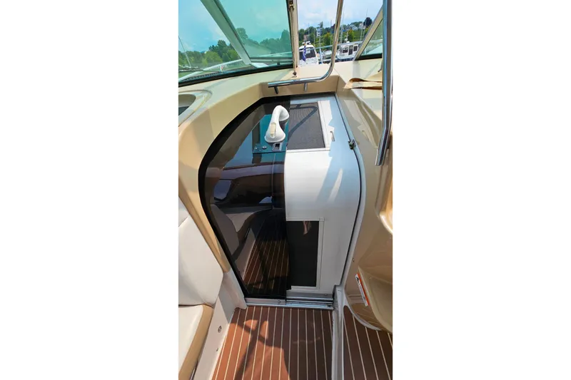 Slide: The Image of Interior view of 2013 Four Winns V335 boat, featuring sleek design and wooden flooring. - 44