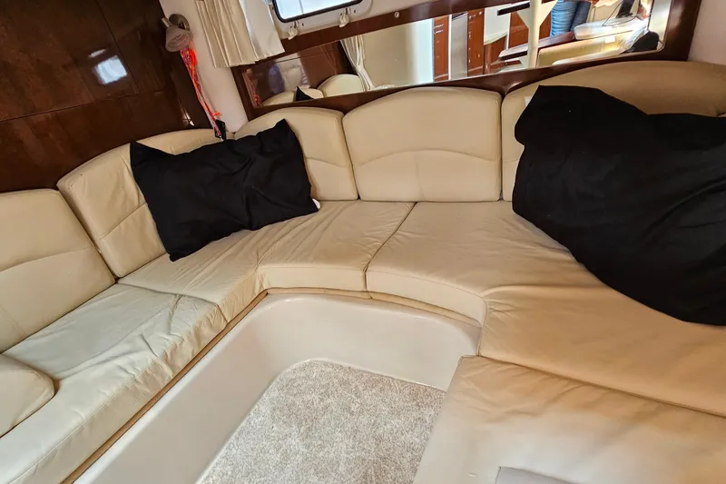 Slide: The Image of Luxurious beige seating area inside a 2013 Four Winns V335 boat cabin. - 27