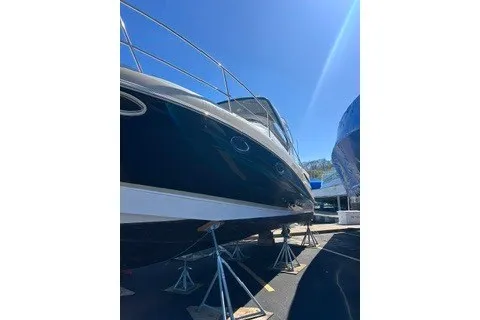 Slide: The Image of 2013 Four Winns V335 boat on stands under clear blue sky. - 3