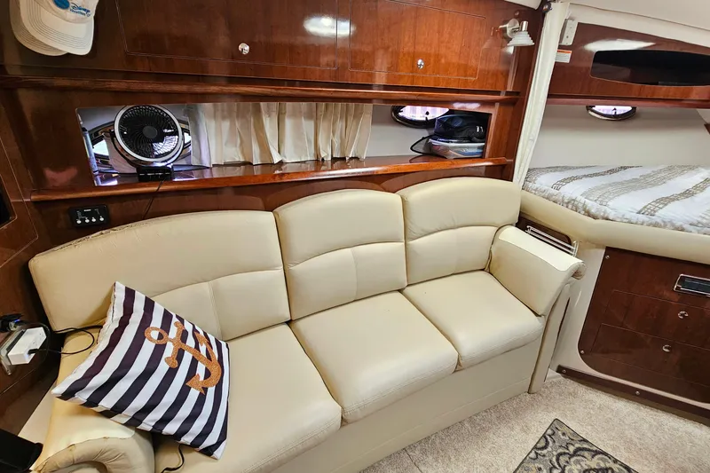 Slide: The Image of Interior of 2013 Four Winns V335 yacht with beige sofa and nautical decor. - 10