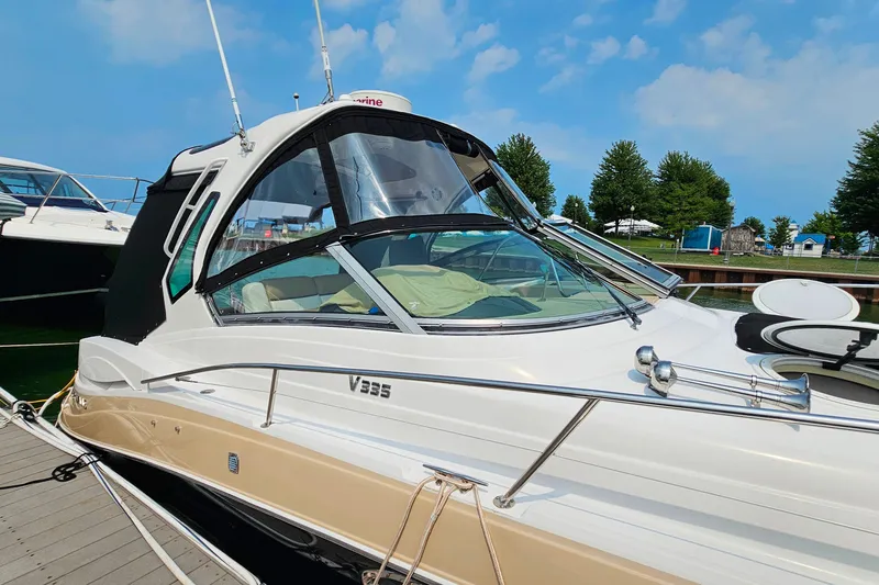 Slide: The Image of 2013 Four Winns V335 boat docked, featuring sleek design and modern amenities. - 46