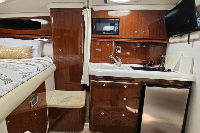 Slide: The Image of Interior of 2013 Four Winns V335 yacht with kitchenette and cozy sleeping area. - 14