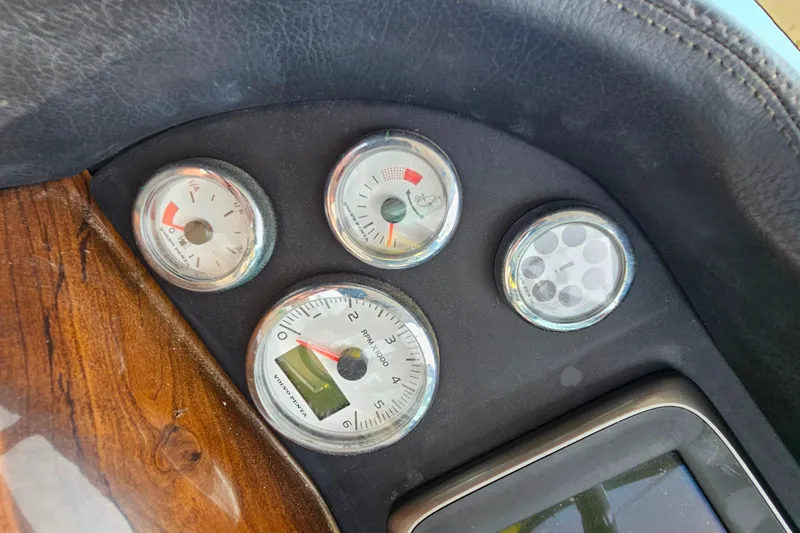 Slide: The Image of Dashboard gauges of a 2013 Four Winns V335 boat, featuring RPM and fuel indicators. - 39